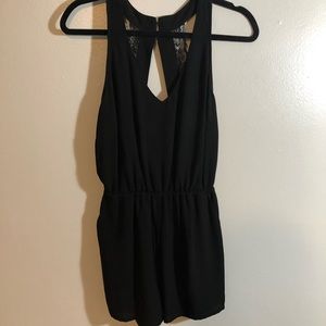Black romper with lace back detailing.